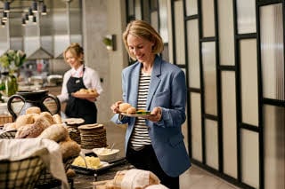 Woman standing beside a breakfast buffet